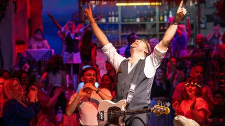 Live music takes centre stage at Mamma Mia! The Party, with performers entertaining guests throughout the evening. Image courtesy of Golden Tours.