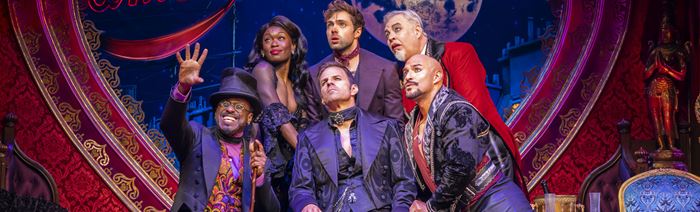 The actors playing in the musical Moulin Rouge are mesmerised by what Toulouse Lautrec tells them. 
