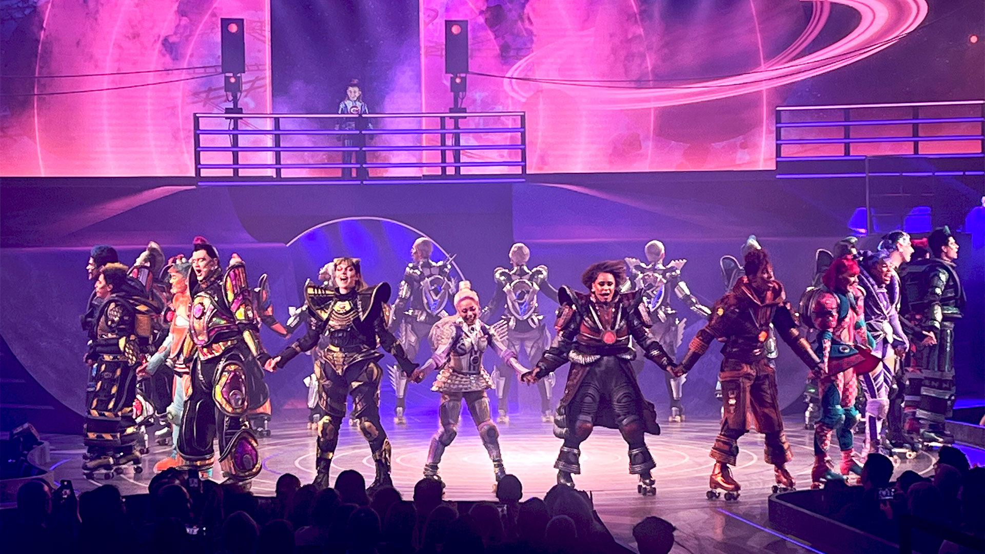 Watch the revival of Starlight Express and marvel at the spectacular roller skating stunts. Image courtesy of Carole Rocton. The cast of Starlight Express stand on roller skates in colourful costumes, bowing to the audience.