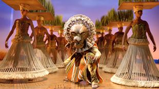 The character King Mufasa in a lion costume takes centre stage in The Lion King.