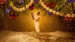 Dancer Ivana Bueno performs on the stage of the London Coliseum where snow falling.