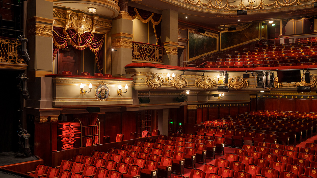 Enjoy fantastic theatre at this historic venue in London. Image courtesy of Sister London. Photo Credit: Andy Paradise. The red seats and lighting of the auditorium in the theatre royal drury lane in london.