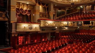 The red seats and lighting of the auditorium in the theatre royal drury lane in london.