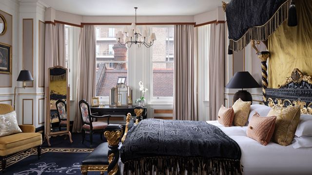 A view of a suite at 11 Cadogan Gardens, featuring black and gold decor and large windows.