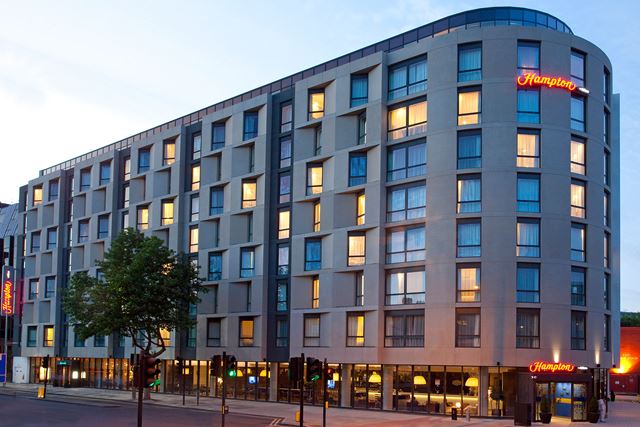 The exterior of Hampton by Hilton London Waterloo at dusk