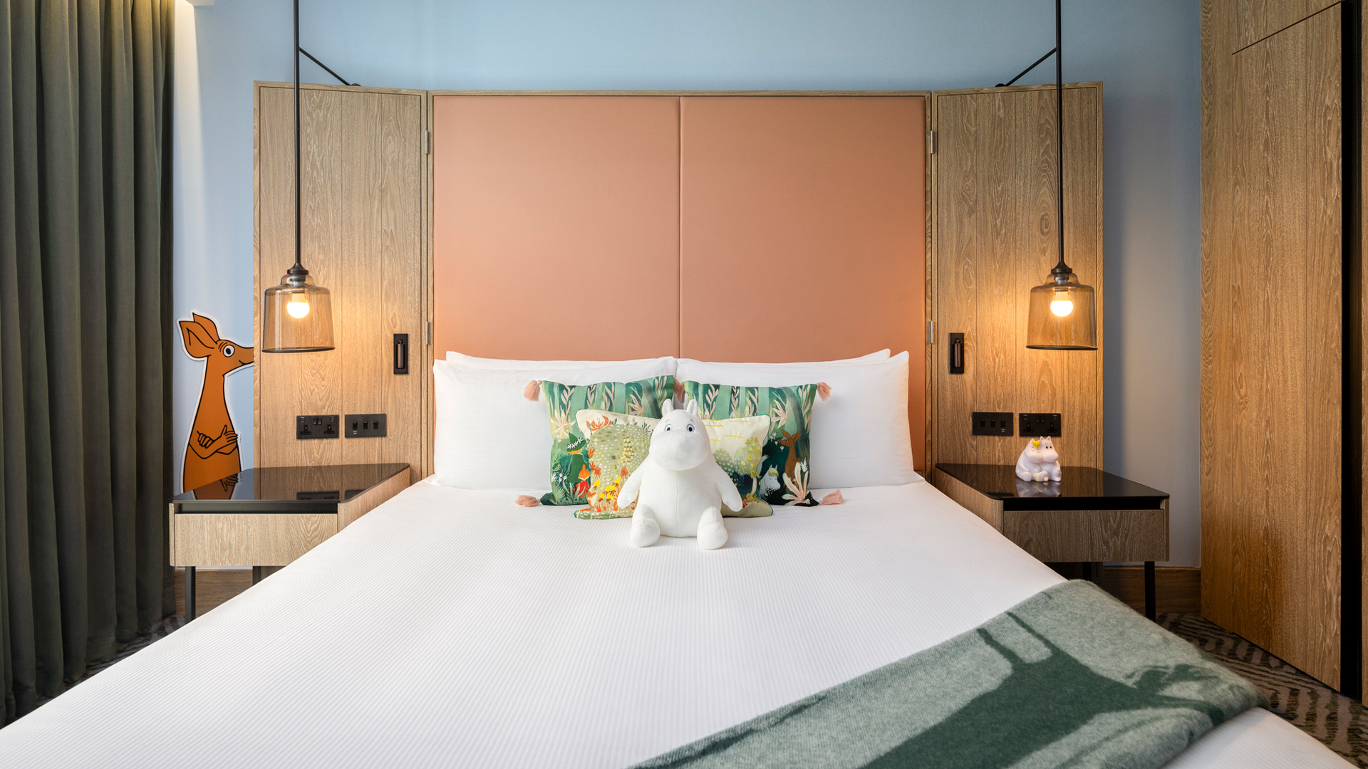 Hilton London Bankside is inviting guests into the world of the Moomins, the beloved characters of Finnish artist Tove Jansson. Image courtesy of Hilton. A white Moomin toy on a double bed in a hotel room
