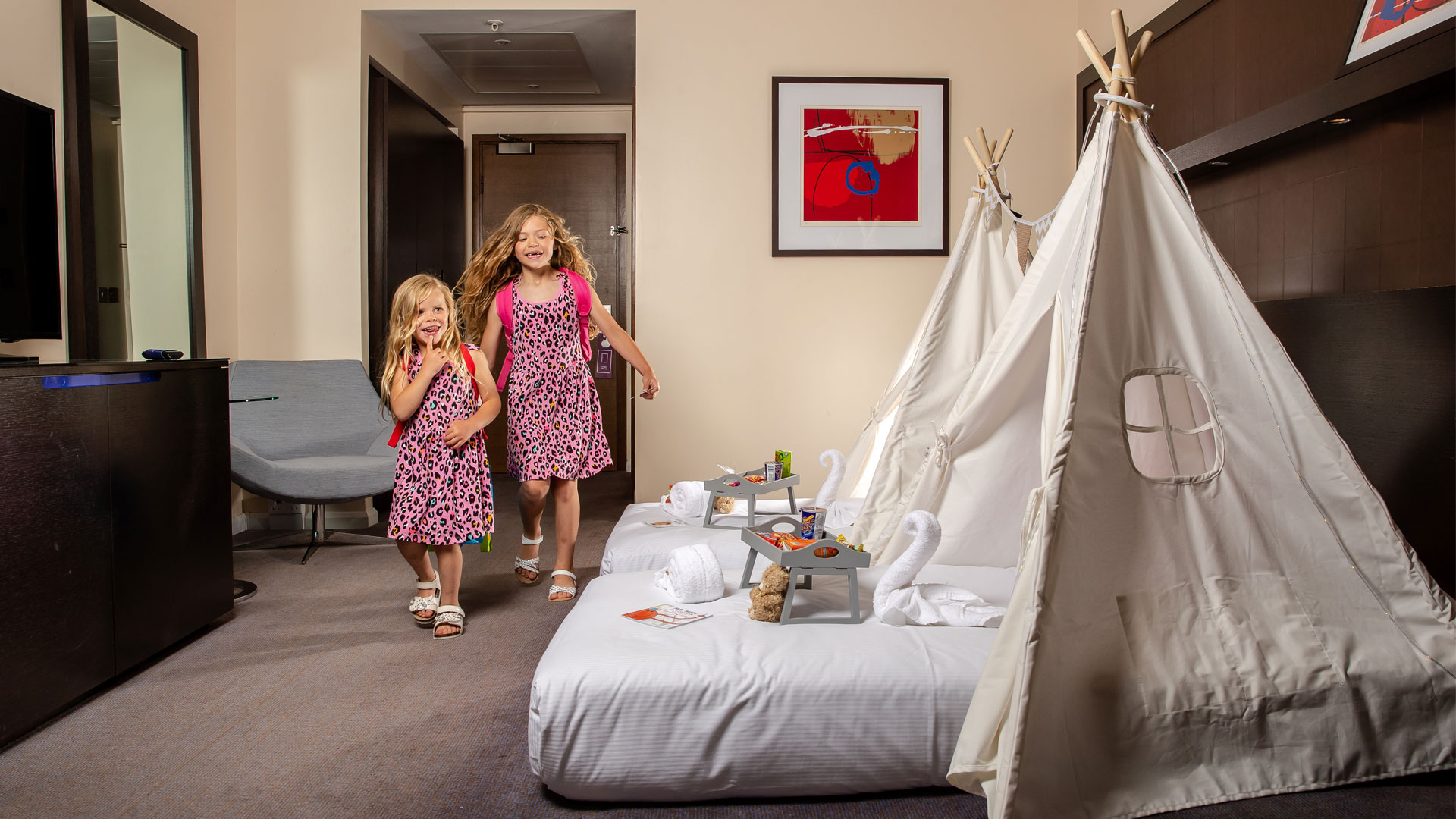 Family room at Hilton London Canary Wharf with tepees and kid's activities on beds.