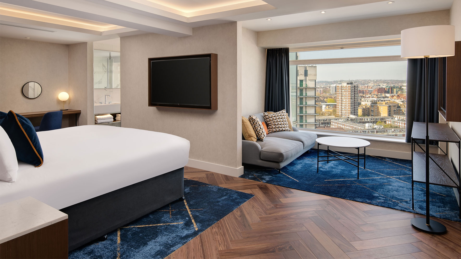 Bedroom and lounge in suite at Hilton London Metropole