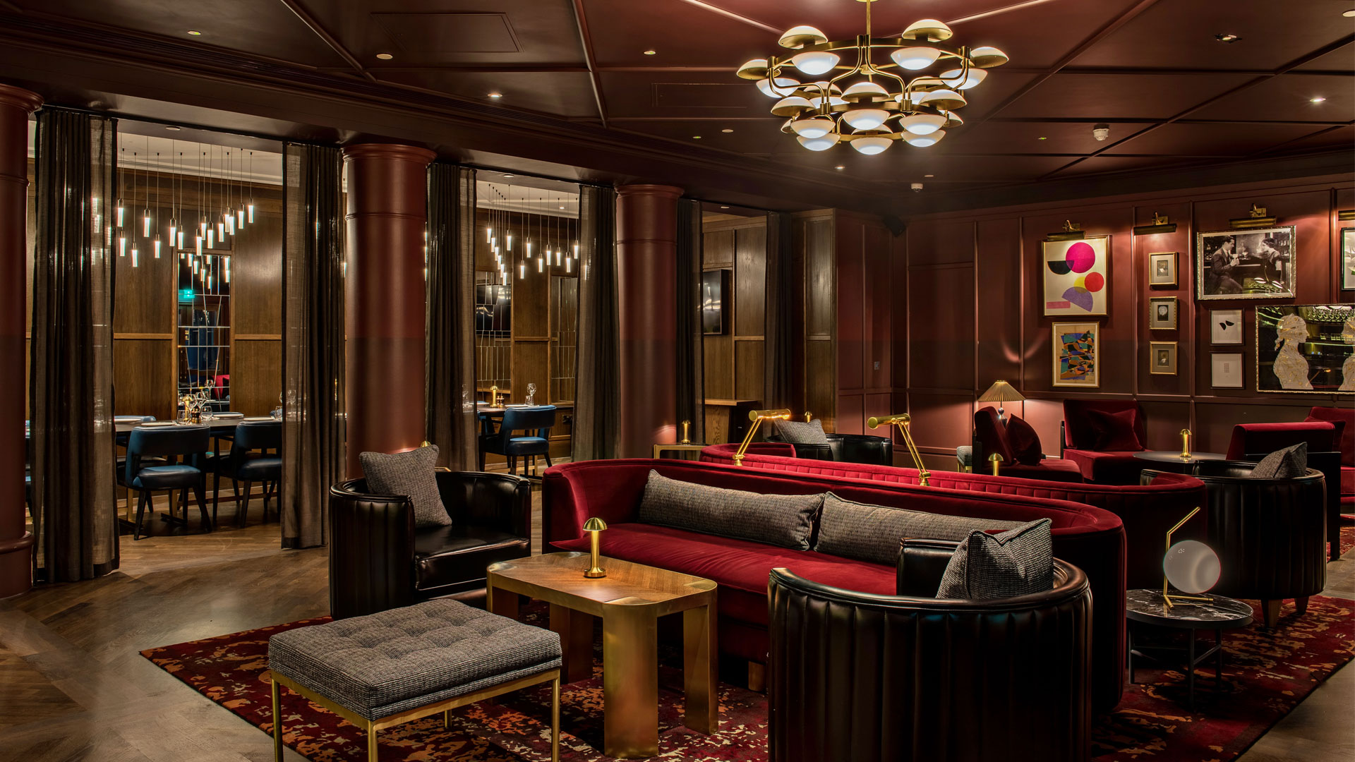 Lounge with dark wood and red seating at The Trafalgar St. James London