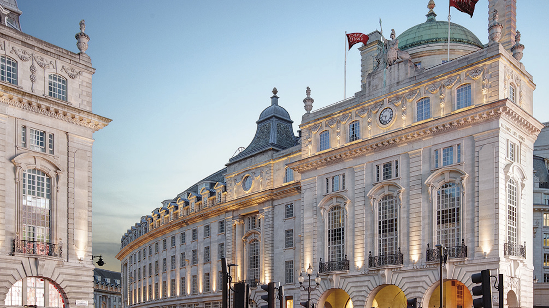 Hotel Café Royal's iconic curved facade on Regent Street on a clear evening.