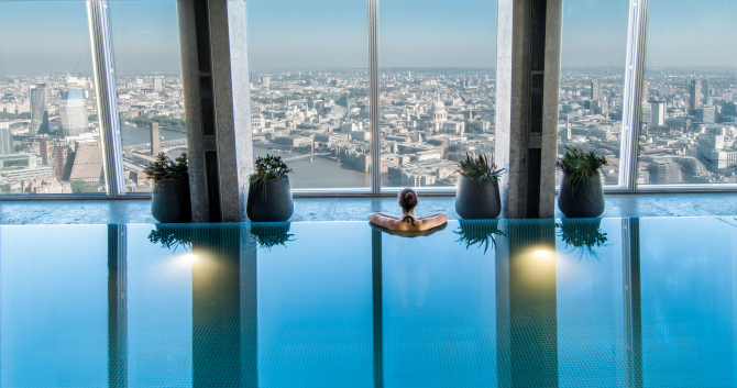Woman looks out over London skyline from Shangri-La The Shard Sky Pool