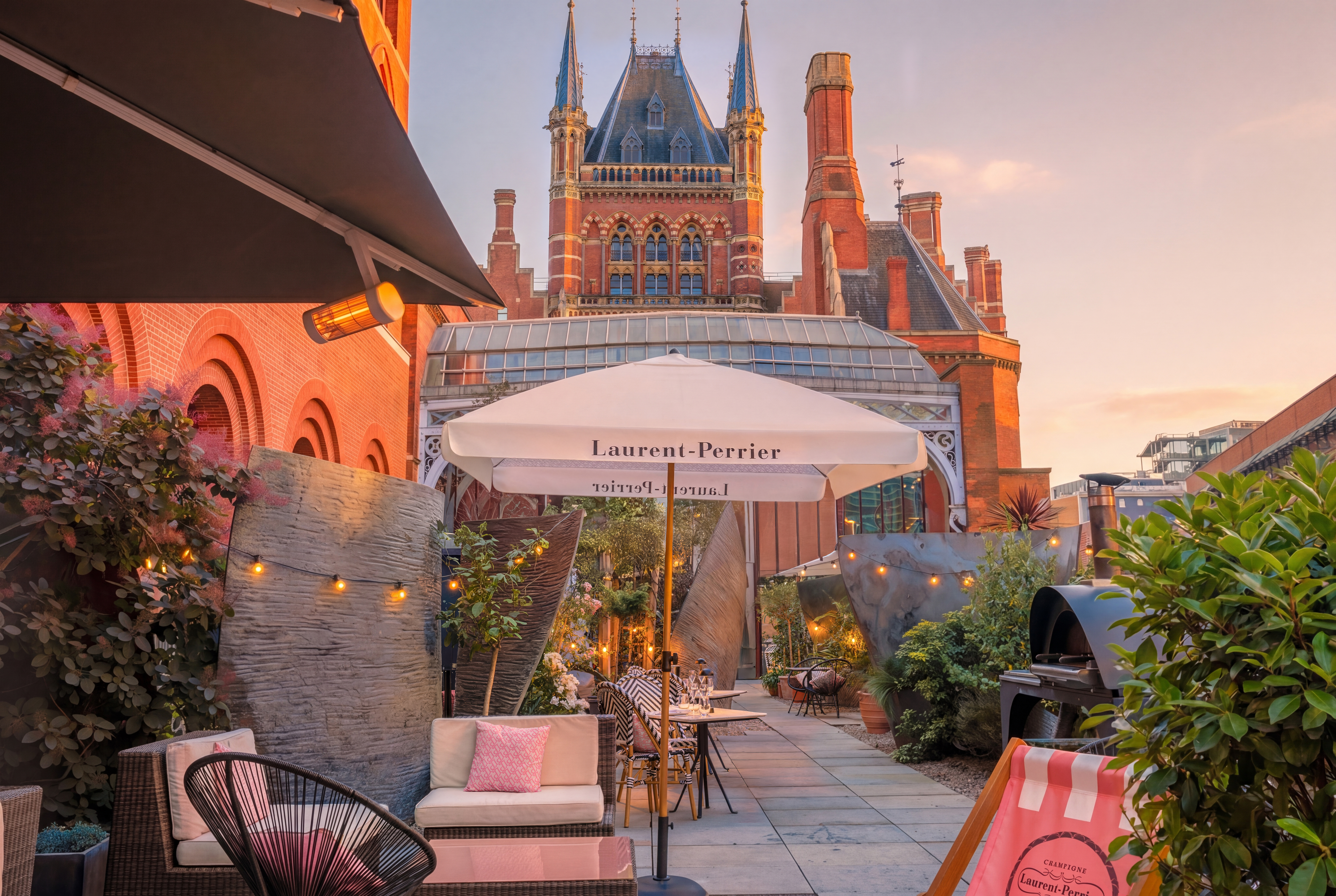 An elegant rooftop terrace in King's Cross with deck chairs and umbrellas.