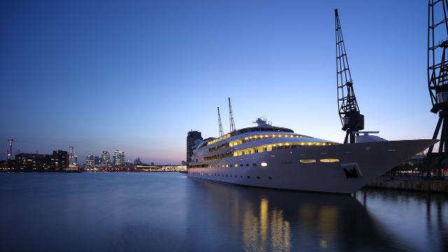 A large yacht, which has been turned into the Sunborn London hotel, taken from the quayside at dusk.
