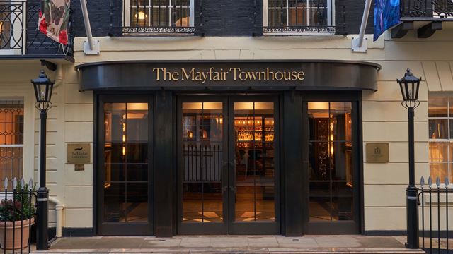 The exterior of The Mayfair Townhouse with a stylish entrance featuring black doors, lampposts and Georgian architecture.