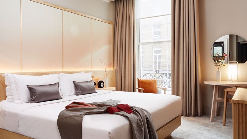Experience a relaxing stay at The Prince Akatoki Hotel in Marble Arch. Credit: The Prince Akatoki Hotel. Image courtesy of The Prince Akatoki Hotel. Double bedroom decorated in neutral tones with Japanese yukata on the bed and grey cushions.